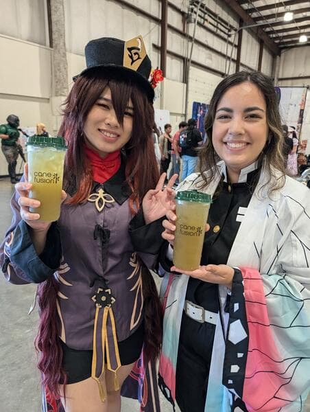 Friends sharing dragon fruit sugarcane juice at a food festival