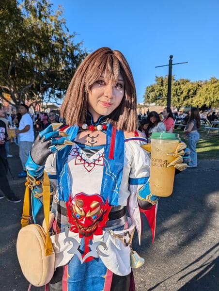 A customer in costume holding Cane Fusion sugarcane juice