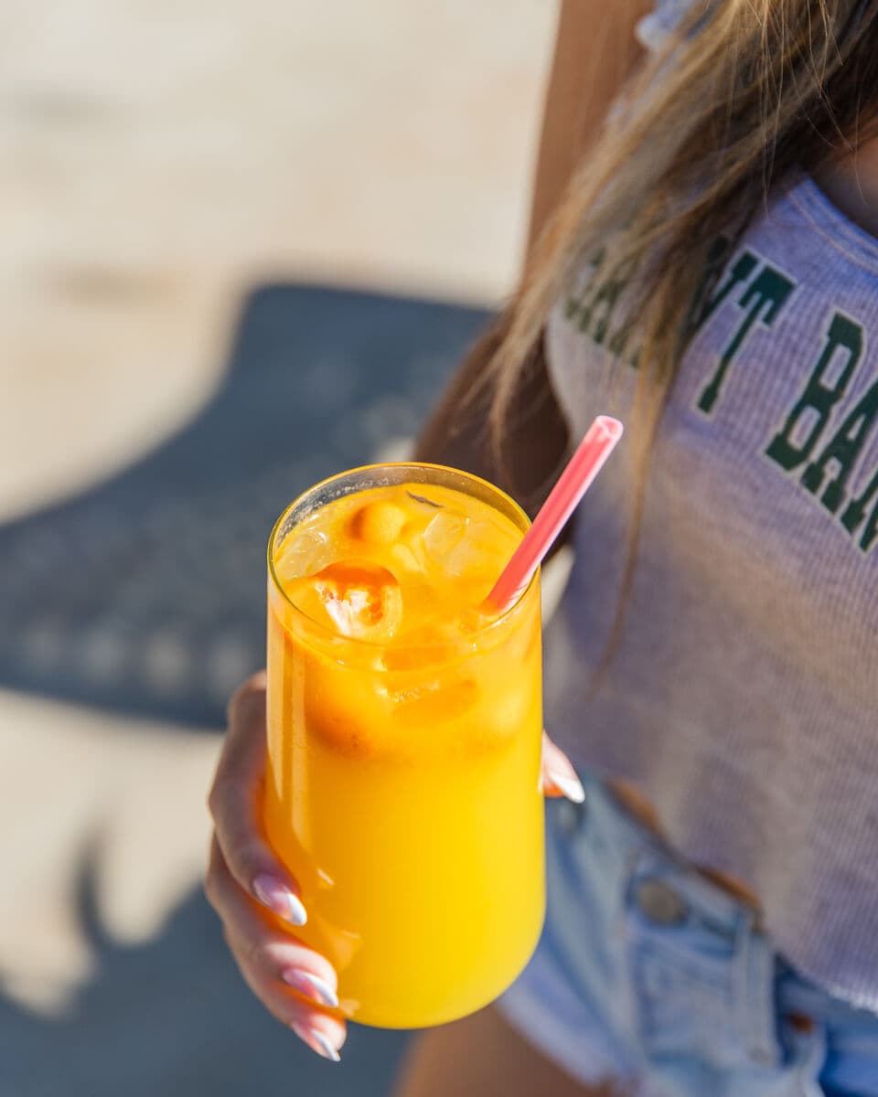 A cup of fresh-pressed sugarcane juice held at a Cane Fusion booth at 626 Night Market